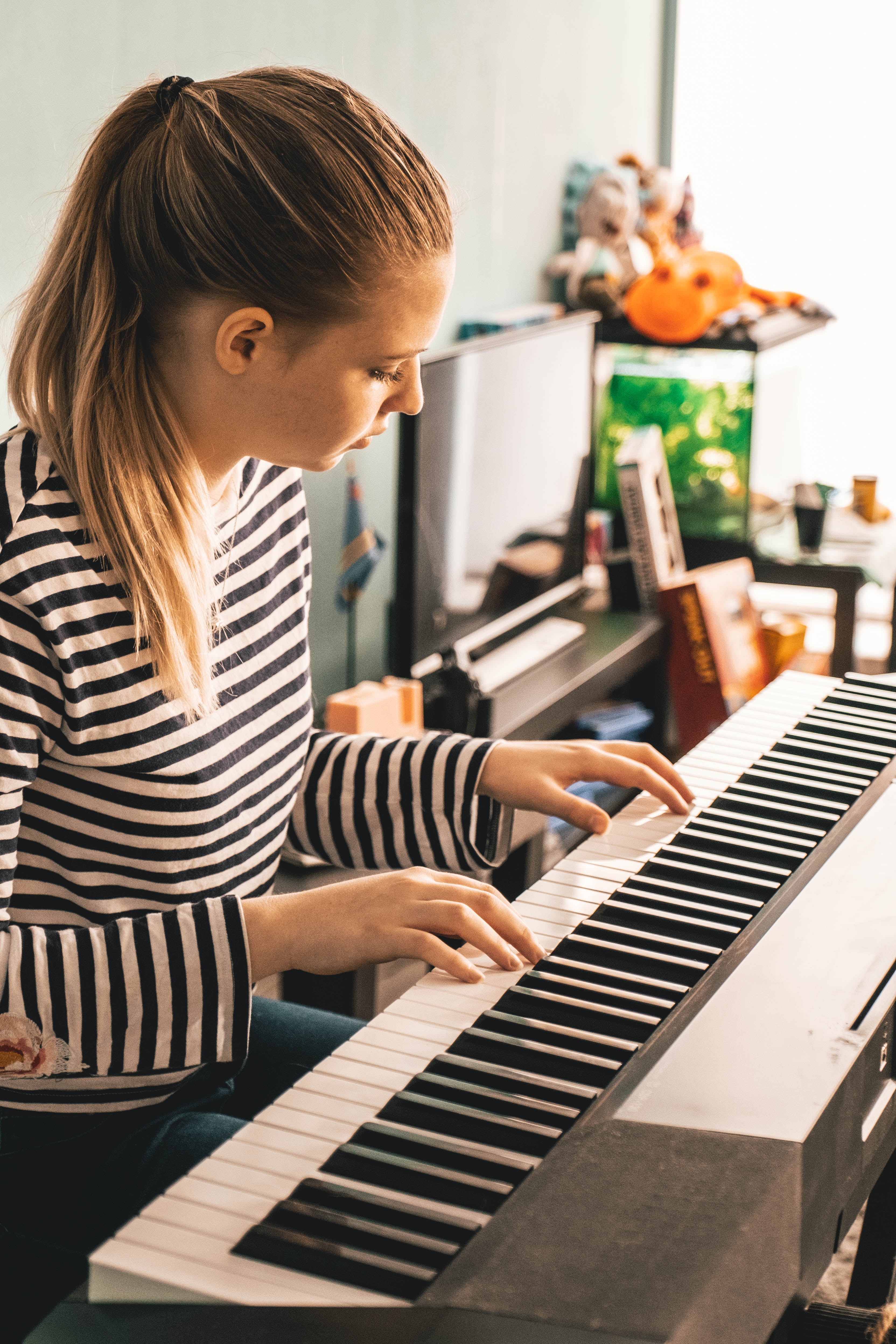 girl learning piano